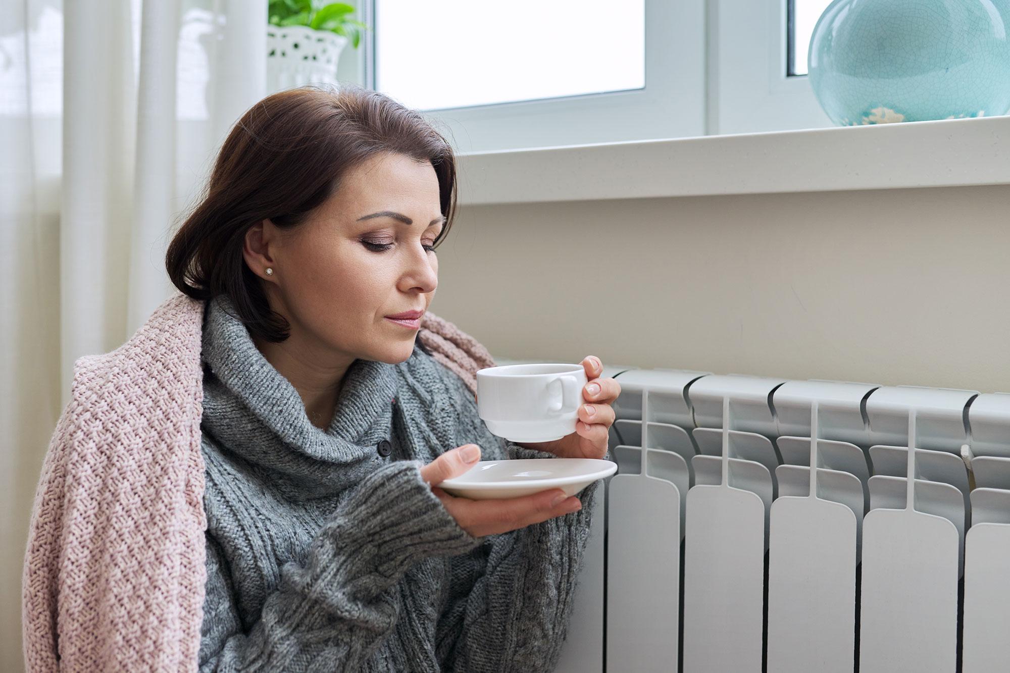 woman-sat-by-raidiator woman sat by radiator